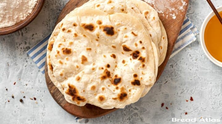 Stack of chapati on wooden board.