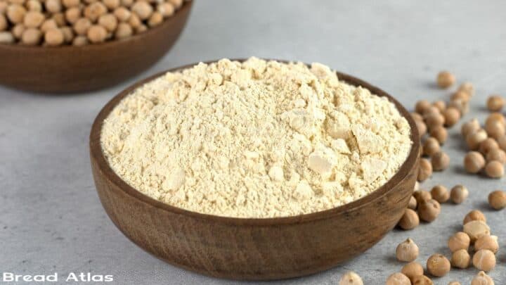 Chickpea flour in a wooden bowl.