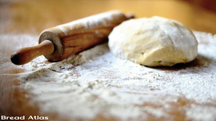 Kneaded dough with a rolling pin in the background.