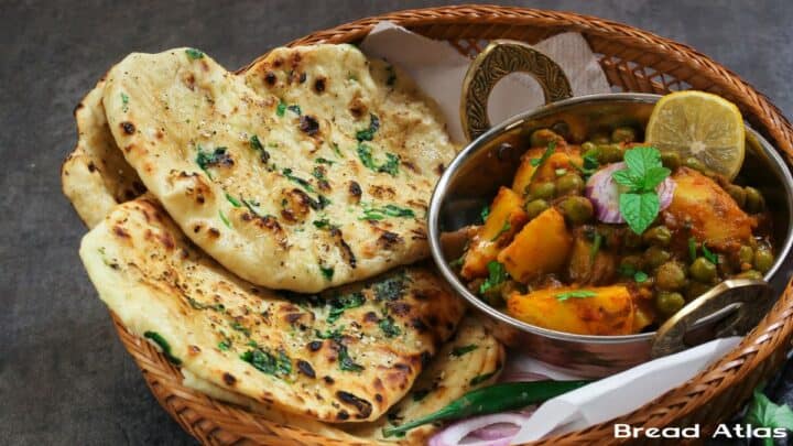Kulcha and potato curry in a bread basket.