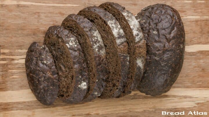 Slices of pumpernickel on a wooden board.