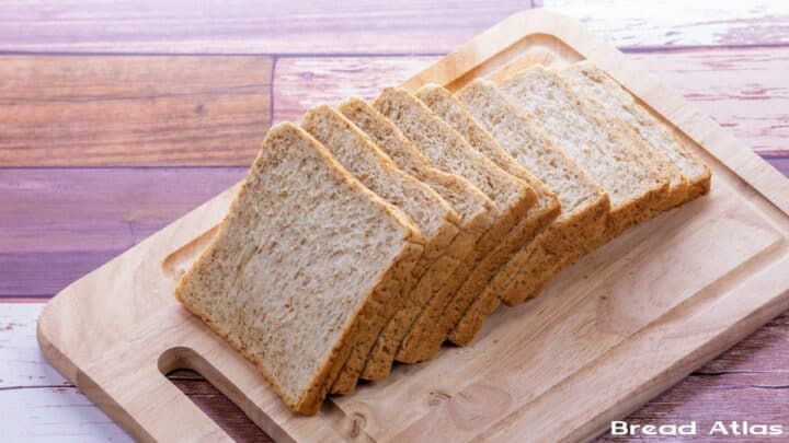 Slices of whole wheat bread on a wooden board.